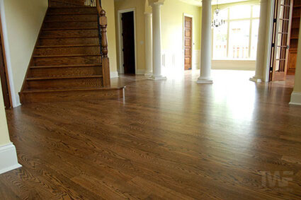 Living room with red oak floor stained Spice Brown